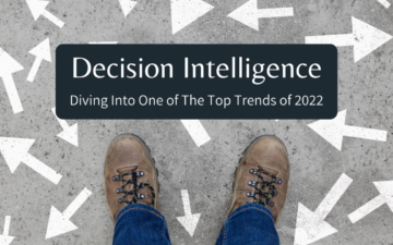 Man standing on a concrete surface containing multiple arrows with the words decision intelligence: diving into one of the top trends of 2022